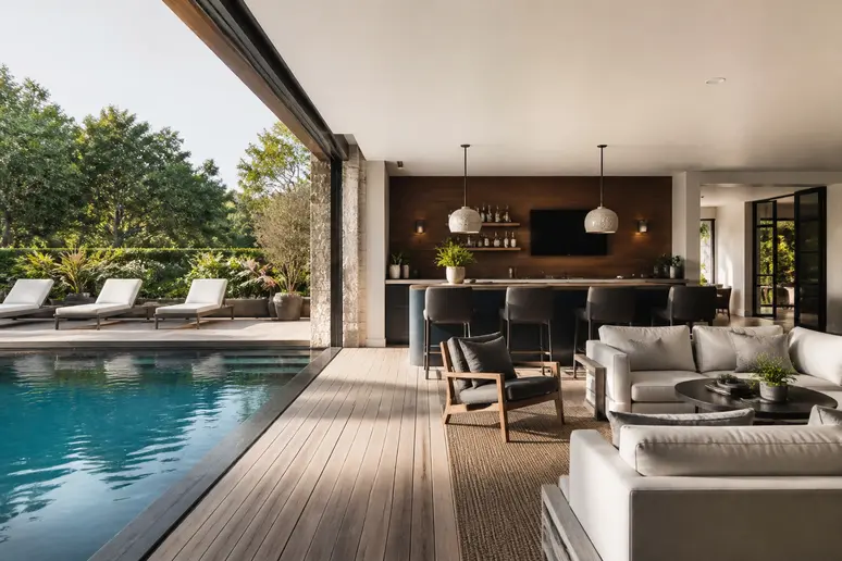 Aménagement intérieur et extérieur d'un pool house moderne avec bar et terrasse.